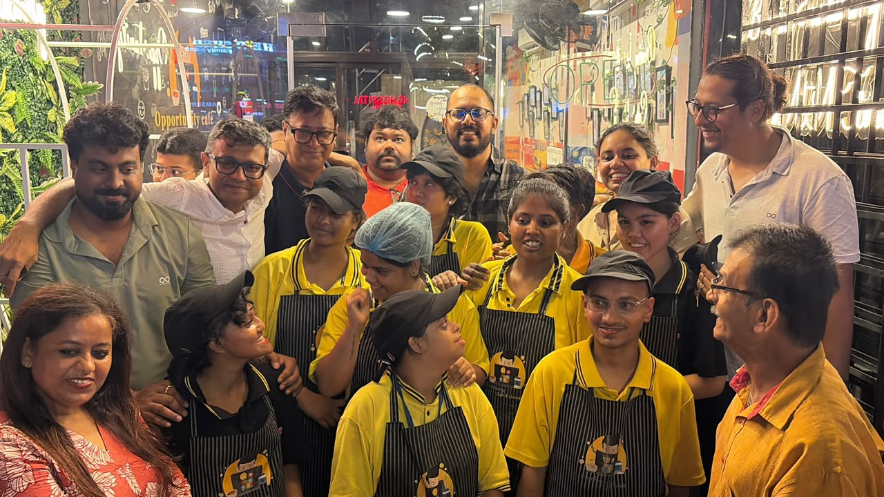 Staff and guests sharing a moment at the Opportunity Cafe counter